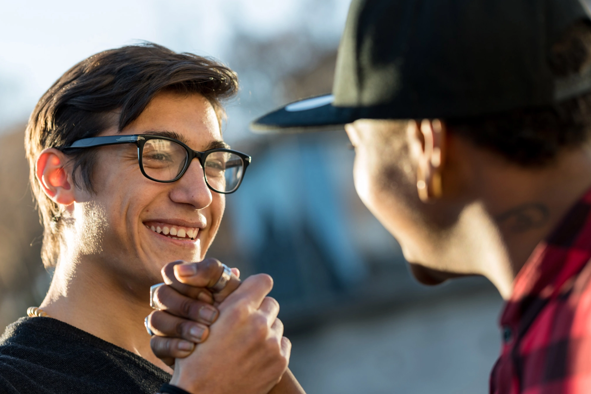 Zwei junge Männer geben sich freudig die Hand